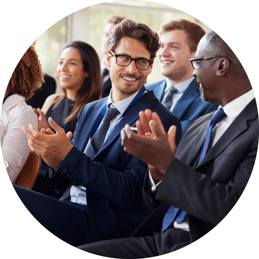 Audience clapping at business seminar, looking at each other