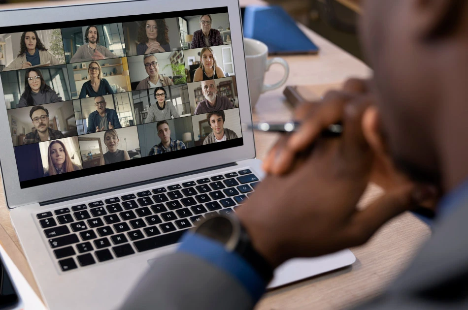 Talking and working on the computer in online conference call Talking and working on the computer in online conference call