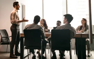 man leading team in conference room